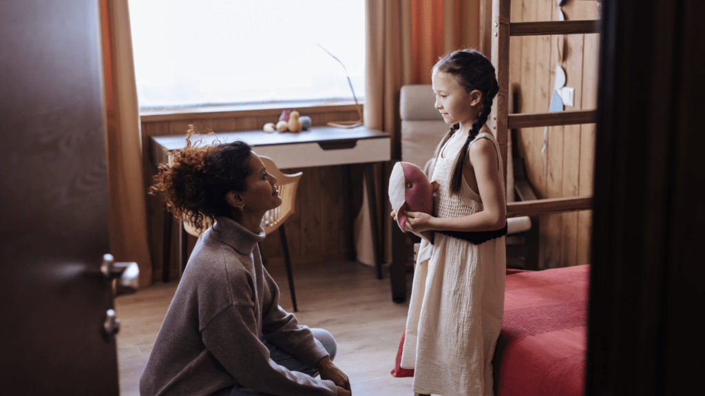 A girl and her mother in a room