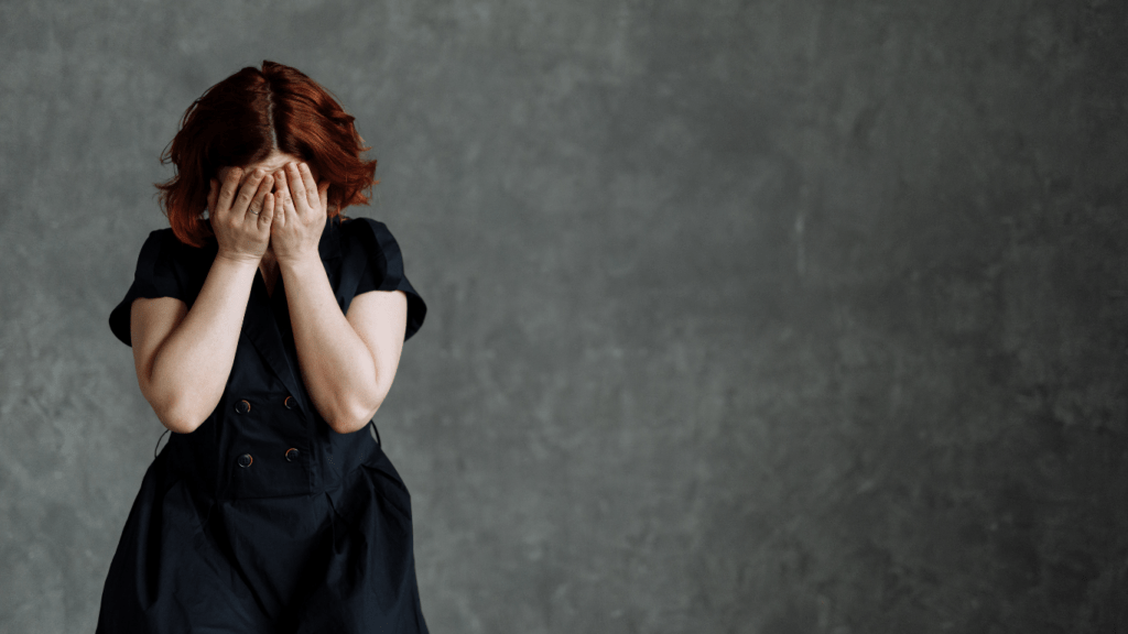 A person covering their face (1)