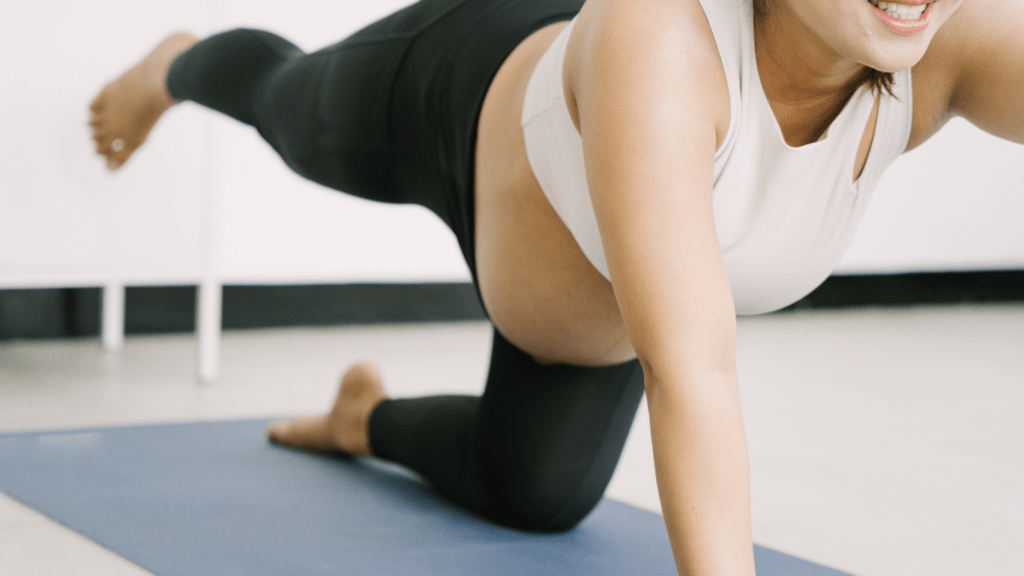 A pregnant person is doing a yoga pose