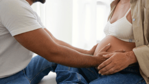 pregnant person and person holding hands