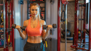 woman exercising with dumbbells at home