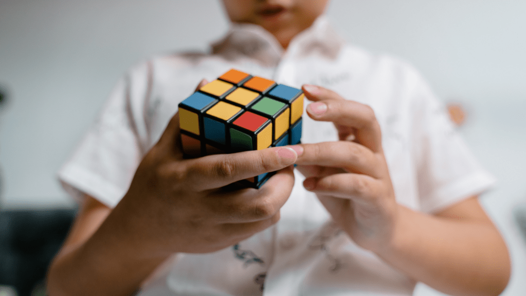 a person holding a rubik cube in their hands