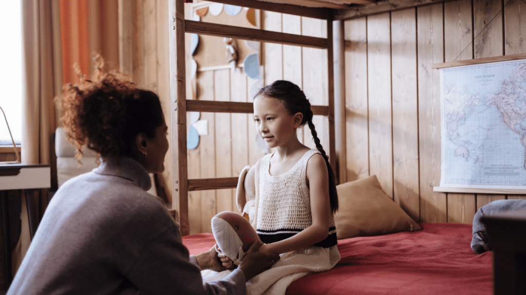 A girl and her mother in a room