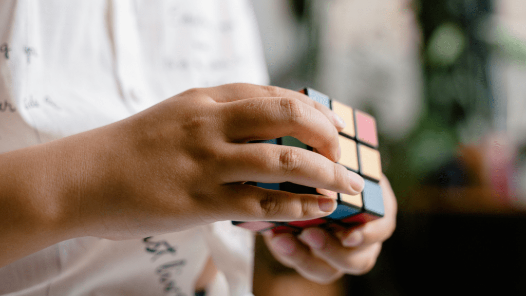 a person holding a rubik cube in their hands